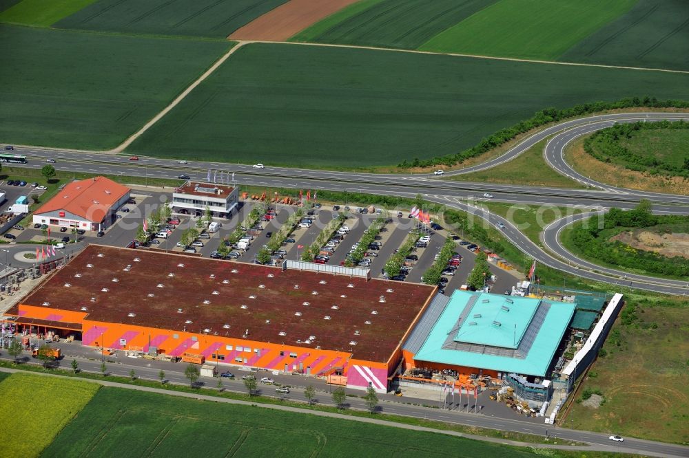 Aerial image Würzburg - Hornbach hardware store in the commercial area and shopping centre B19 in Wuerzburg in the state of Bavaria. The shopping centre includes shopping facilities and malls of large chains such as convenience and furniture stores, children and animals stores. The centre is located on the federal highway B19, next to IKEA. The Hornbach store has its own entrance, large parking lot and is coloured in the red and orange of the chain