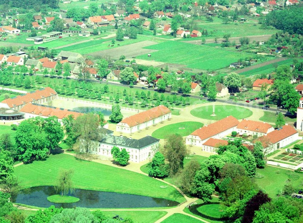 Aerial photograph Neuhardenberg (ehem. Marxwalde) / Brandenburg - Hotel Schloss Neuhardenberg am Tage der Wiedereröffnung nach umfangreichen Restaurations- und Sanierungsarbeiten. Inmitten eines von Peter Joseph Lenné und Hermann Fürst von Pückler-Muskau gestalteten Landschaftparks gelegen, bietet Hotel Schloss Neuhardenberg Komfort und Ruhe. Es verfügt über Räumlichkeiten verschiedener Größe für Gespräche, Tagungen und Konferenzen, aber auch für Feierlichkeiten. Für die Planung und Gestaltung von Konferenzen, Tagungen und Gesprächen und des entsprechenden kulturellen und kulinarischen Begleitprogramms unterbreitet Ihnen der Veranstaltungsservice von Hotel Schloss Neuhardenberg unter der Telefonnummer +49 (0)30 - 889 290-15 gerne detaillierte Arrangementvorschläge. Einzelreservierungen werden unter der Telefonnummer +49 (0)30 - 889 290-0 entgegen genommen. Hotel Schloss Neuhardenberg wird in Zusammenarbeit mit den Althoff Hotels betrieben. Neuhardenberg 08.05.2001