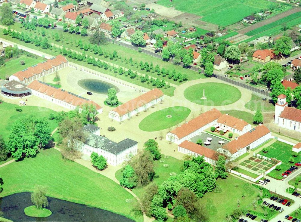 Aerial photograph Neuhardenberg (ehem. Marxwalde) / Brandenburg - Hotel Schloss Neuhardenberg am Tage der Wiedereröffnung nach umfangreichen Restaurations- und Sanierungsarbeiten. Inmitten eines von Peter Joseph Lenné und Hermann Fürst von Pückler-Muskau gestalteten Landschaftparks gelegen, bietet Hotel Schloss Neuhardenberg Komfort und Ruhe. Es verfügt über Räumlichkeiten verschiedener Größe für Gespräche, Tagungen und Konferenzen, aber auch für Feierlichkeiten. Für die Planung und Gestaltung von Konferenzen, Tagungen und Gesprächen und des entsprechenden kulturellen und kulinarischen Begleitprogramms unterbreitet Ihnen der Veranstaltungsservice von Hotel Schloss Neuhardenberg unter der Telefonnummer +49 (0)30 - 889 290-15 gerne detaillierte Arrangementvorschläge. Einzelreservierungen werden unter der Telefonnummer +49 (0)30 - 889 290-0 entgegen genommen. Hotel Schloss Neuhardenberg wird in Zusammenarbeit mit den Althoff Hotels betrieben. Neuhardenberg 08.05.2001