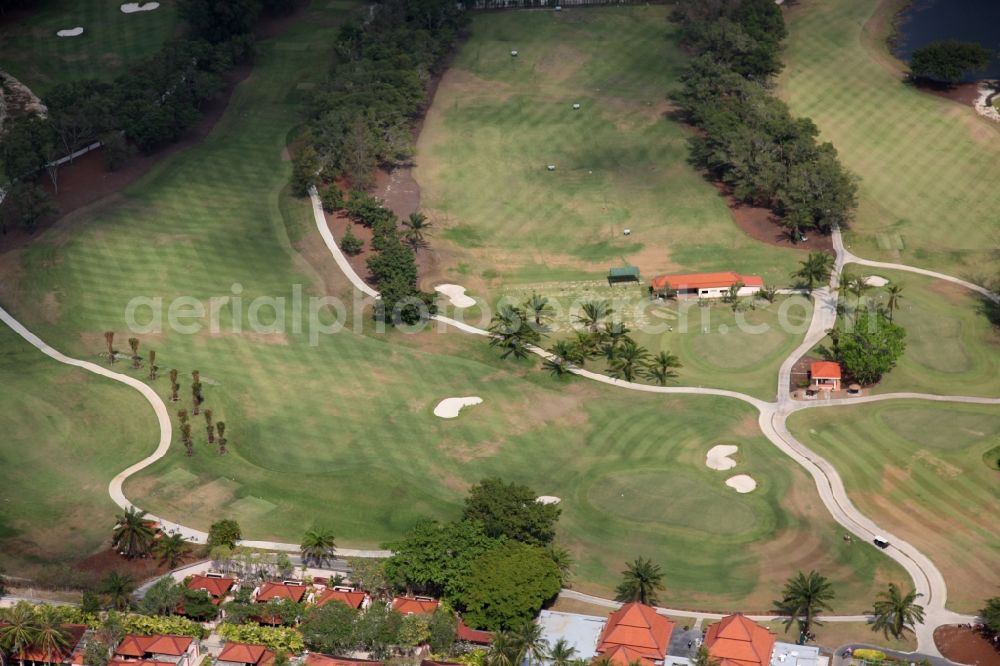 Choeng Thale from the bird's eye view: Resort and golf course with cottages partially of typical architectural style of buildings in Choeng Thale on the island of Phuket in Thailand