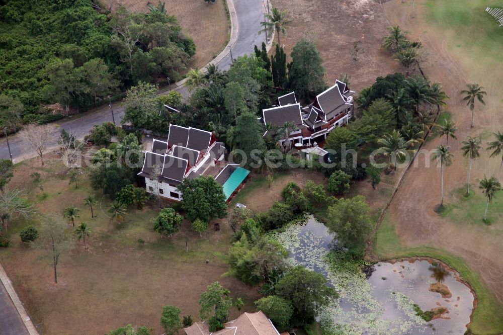 Choeng Thale from the bird's eye view: Resort and golf course with cottages partially of typical architectural style of buildings in Choeng Thale on the island of Phuket in Thailand