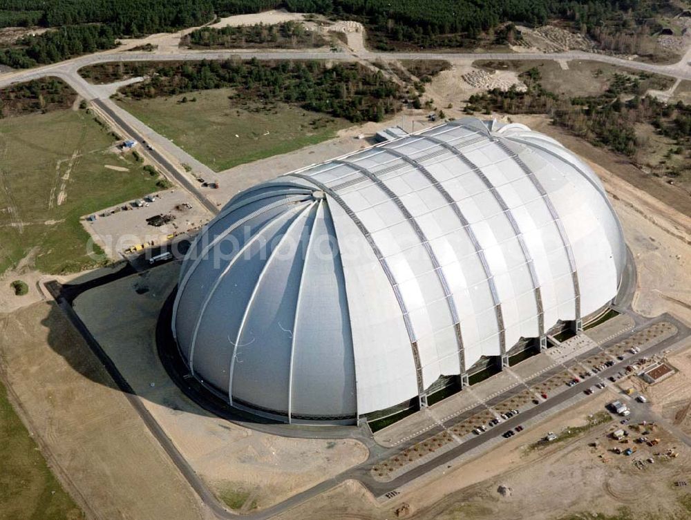 Aerial photograph Krausnik - Die größte frei tragende Halle der Welt bietet genug Platz für ein Tropenparadies. In den kommenden Monaten findet die Verwandlung vom Cargolifter Hangar, der ehemaligen Produktionsstätte für Transportluftschiffe, zum Tropical Islands Dome mit seinem einzigartigen Attraktionen statt. Tropical Island Management GmbH,Tropical-Islands-Allee 1,15910 Krausnick – Gross Wasserburg,Tel: +49-35477-60-100,Fax: +49-35477-60-3129 ,http://