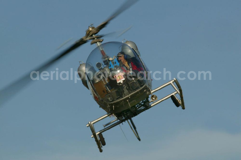 Giengen an der Brenz from above - Hubschrauber vom Typ Bell 47 fliegt nahe dem Flugplatz Giengen EDNG in Baden-Württemberg. Helicopter near by the Giengen airfield in Baden-Wuerttemberg.