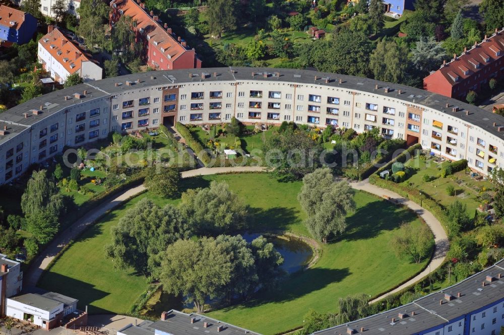 Berlin from the bird's eye view: View of Horseshoe settlement in Berlin-Britz. The Hufeisensiedlung was builded from 1925 to 1933 in Berlin-Britz, designed by Bruno Taut and Martin Wagner. It is one of the first projects of social housing and part of the large settlement Britz / Fritz Reuter city. Since 2008 it has been a UNESCO World Heritage Site. The horseshoe itself is still owned by the GEHAG, under the roof of the Deutsche Wohnen AG