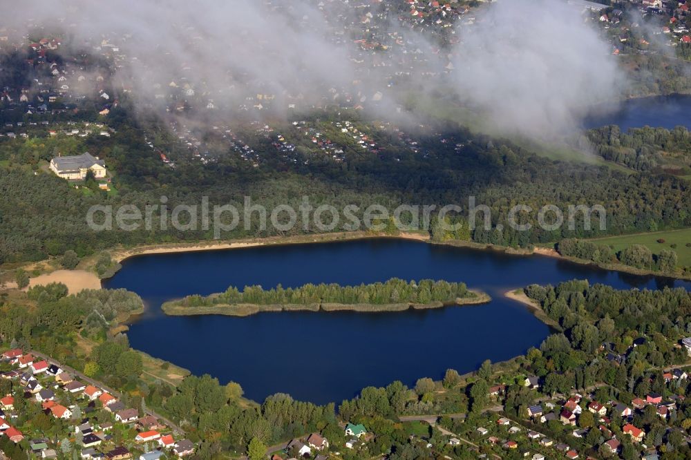  from above - View of clouds circling the countryside surrounding the Habermannsee, one of three Kaulsdorfer Lakes in Berlin. The lakes are located in a nature preserve surrounded by localities with small houses