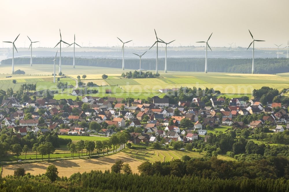 Marsberg OT Essentho from above - Community Essentho near Marsberg in the state of North Rhine-Westphalia with the Sintfeld with wind turbines on it in the background