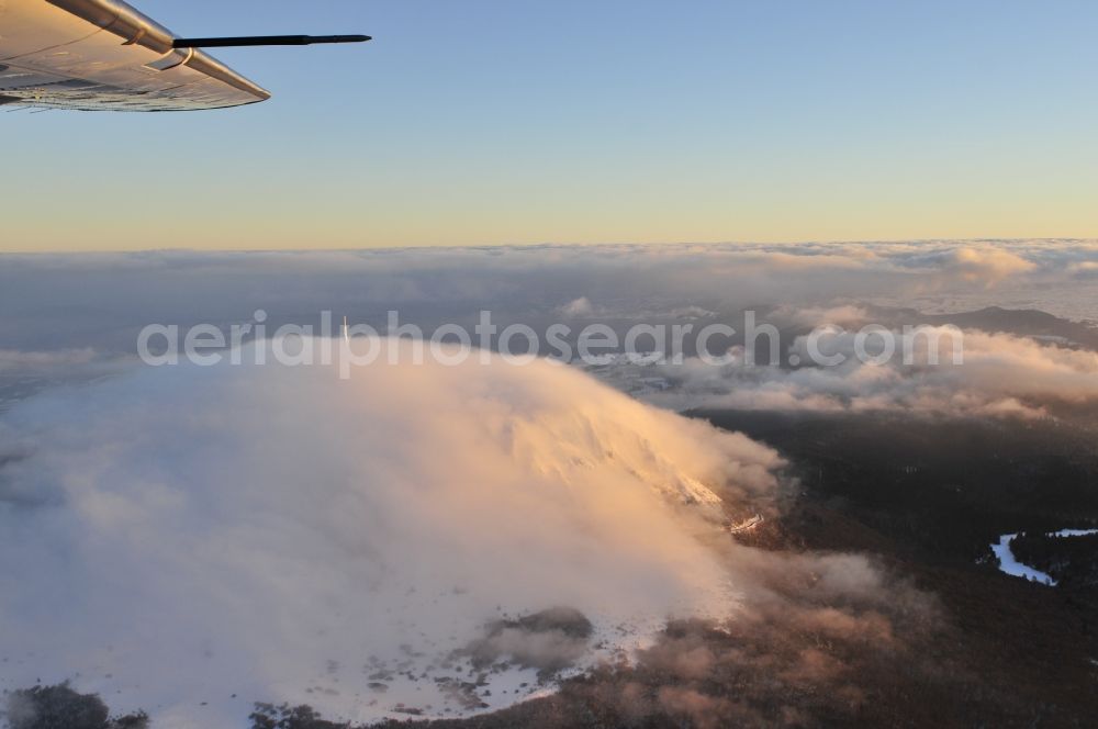 Aerial photograph Puy de Dome - In veiled sunset with fog volcanic mountain Puy-de-Dome in the province of Auvergne in France