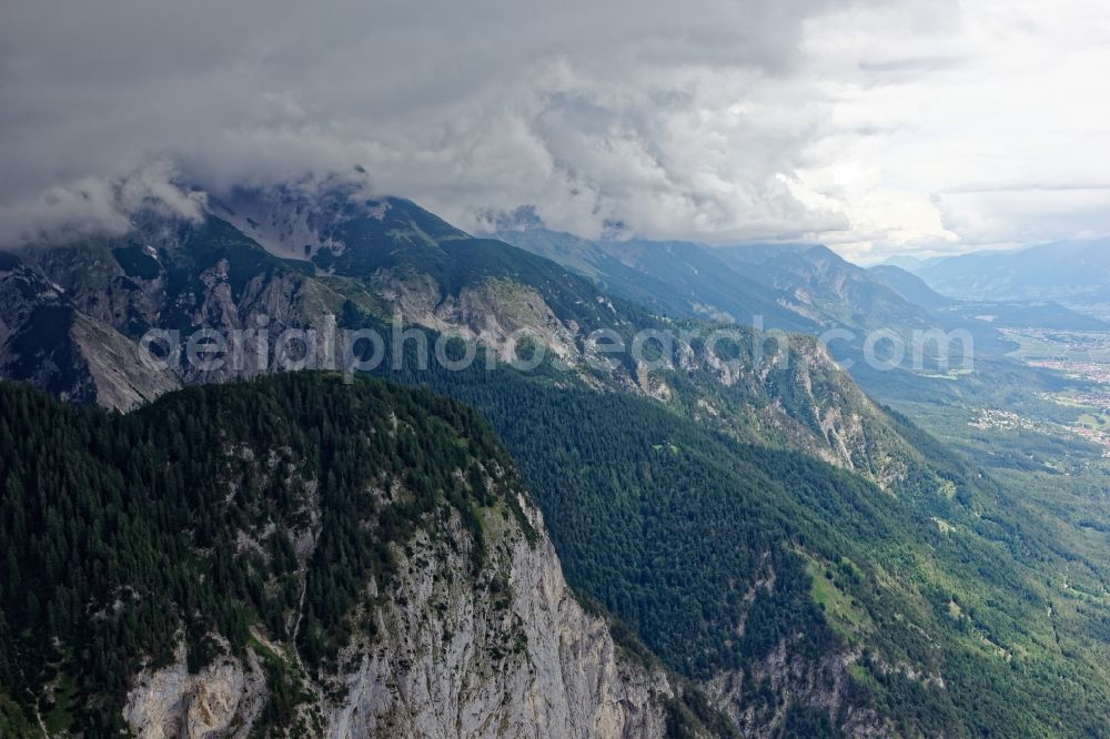 Aerial photograph Innsbruck - Rocky and mountainous landscape with Hechenberg peak in clouds in Innsbruck in Tirol, Austria