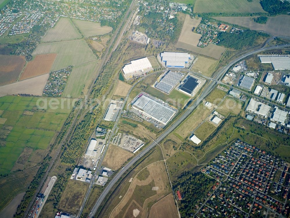 Großbeeren from above - Industrial estate and company settlement along the B101 road in Grossbeeren in the state of Brandenburg. The area with its different companies and business areas is surrounded by the residential areas of Grossbeeren and Teltow and by fields and meadows