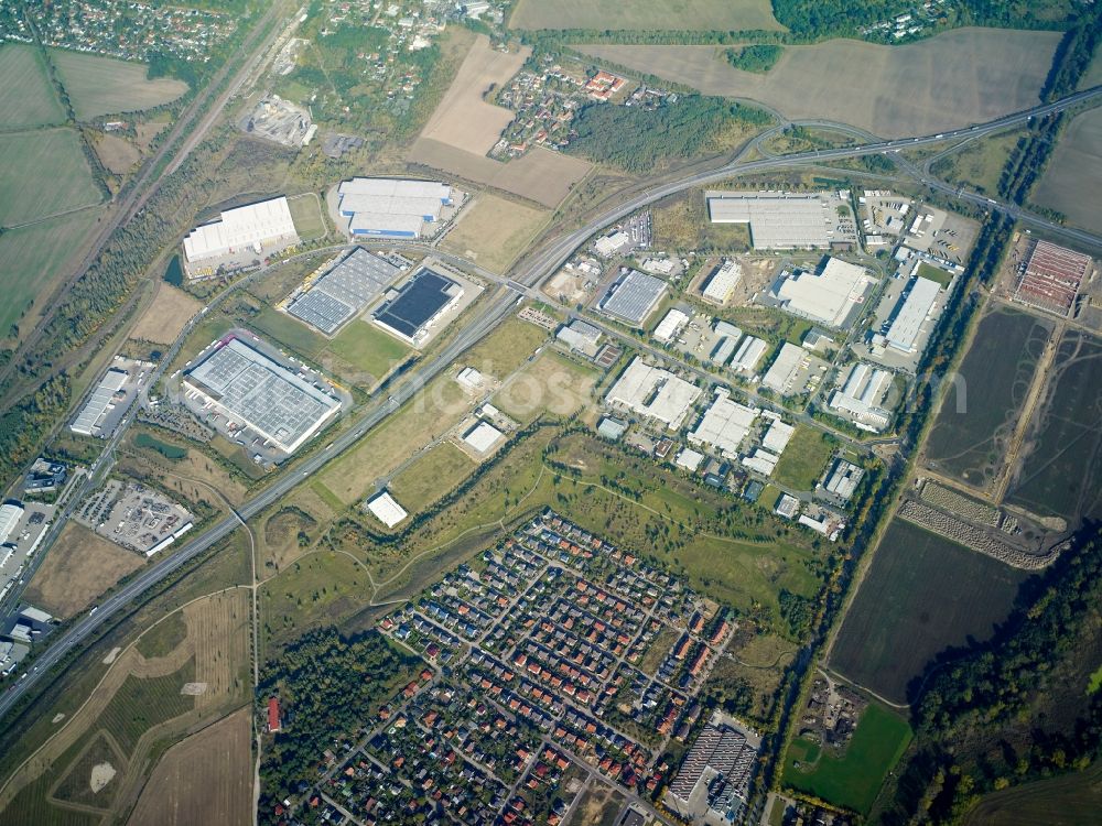 Großbeeren from above - Industrial estate and company settlement along the B101 road in Grossbeeren in the state of Brandenburg. The area with its different companies and business areas is surrounded by the residential areas of Grossbeeren and Teltow and by fields and meadows