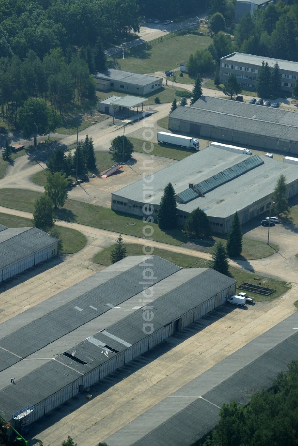 Aerial photograph Grünheide (Mark) - Industrial and commercial area in the Hangelsberg part of the borough of Gruenheide (Mark) in the state of Brandenburg. The site includes several large halls as well as industrial and office buildings