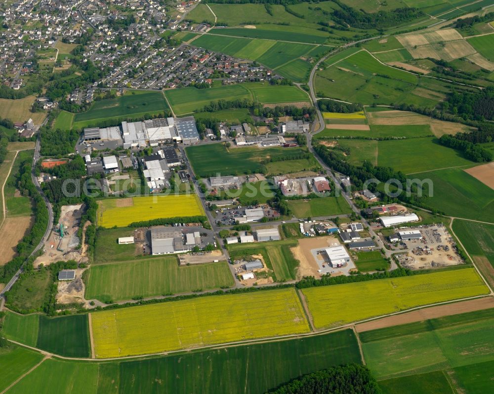 Miehlen from above - Industrial area in the South of the borough of Miehlen in the state of Rhineland-Palatinate. The borough and municipiality is located in the county district of Rhine-Lahn, in the Western Hintertaunus mountain region. The agricultural village includes a large industrial area with company compounds and halls