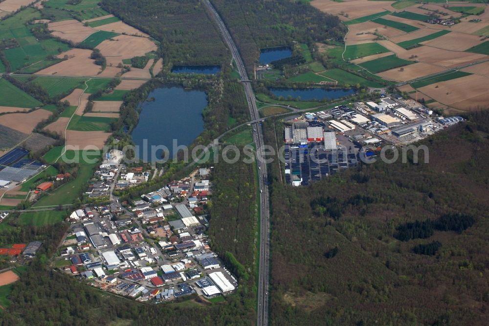 Teningen from the bird's eye view: Industrial and commercial area Rohrlache and bathing lake in Teningen in the state Baden-Wuerttemberg, Germany