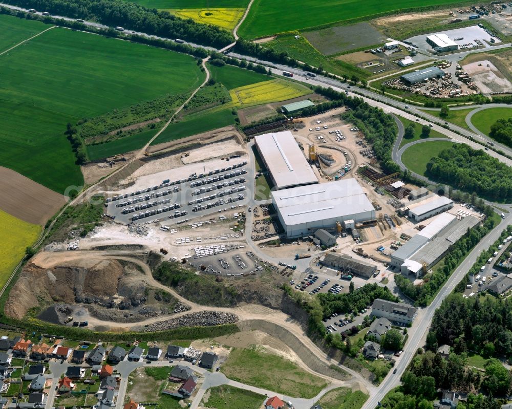 Aerial photograph Plaidt - Industrial compound in Plaidt in the state of Rhineland-Palatinate. The borough and municipiality is located in the county district of Mayen-Koblenz in the North of the federal motorway A61 in the valley of the river Nette. The industrial site with two halls of the Romey Construction Material company is located adjacent to the federal motorway