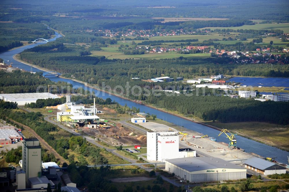 Aerial image Eberswalde - Industrial area in the inland port in the city of Eberswalde Forestry on the banks of the Oder-Havel Canal in Brandenburg. In the image of the company branch Howee GmbH, HOKAWE GmbH, the DBD GmbH, a grain warehouse with conveyor bridge and a logistics center