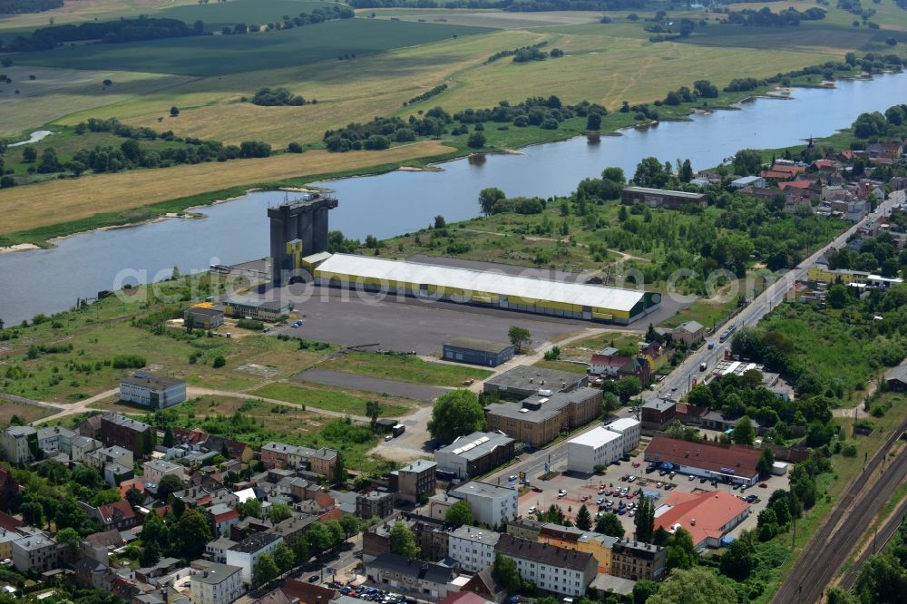 Magdeburg from above - Industrial area on the riverbank of the Elbe and former compound of Fahlberg-List in Magdeburg in the state Saxony-Anhalt.The historic buildings of the former sugar factory with its elongated hall and three silos on the riverbank are listed as protected buildings. The area belongs to the Wusterhuesen and Salbke parts in the South of Magdeburg