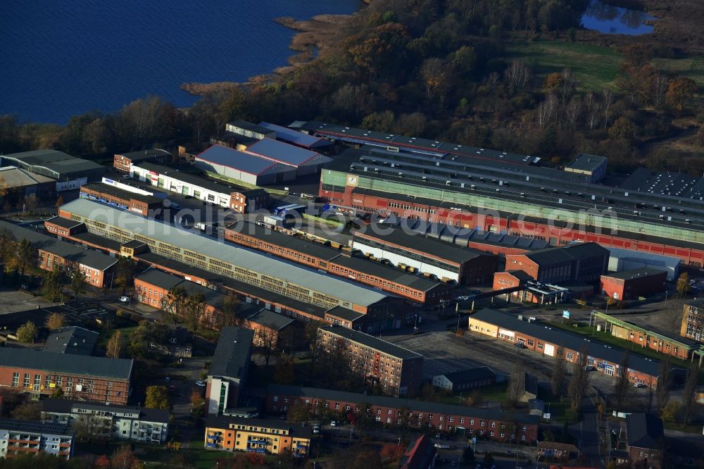 Aerial image Neubrandenburg - Industrial area with production and factory sites as well as warehousing and logistics halls in Neubrandenburg in the state Mecklenburg-West Pomerania. The area is place of the following companies: Mues Werkzeugbau GmbH, UPS Depot of United Parcel Service Deutschland Inc. & Co. OHG, WEKA Holzbau GmbH, ATN Autoservice Neubrandenburg, NTN GmbH IVECO workshop, LAMAHA GmbH, Metallbau MBM Zan der, N-A-F-T GmbH. The area is located on Tollensesee and along the Nonnenhofer Strasse