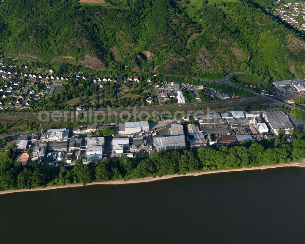 Aerial photograph Lahnstein - Industrial area on the riverbank of the Rhine in the South of Lahnstein in the state Rhineland-Palatinate. The town is located in the county district of Rhine-Lahn, at the mouth of the river Lahn into the river Rhine. The spa resort includes thermal spas and health centres and sits in the UNESCO world heritage site of Upper Middle Rhine Valley. The industrial area is located in the South of railway tracks and the federal highway B42