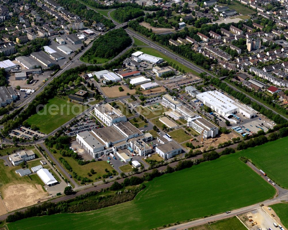 Aerial photograph Andernach - Industrial area in the South of Andernach in the state of Rhineland-Palatinate. The town is located in the county district of Mayen-Koblenz on the left riverbank of the river Rhine. The town is characterised by industry, consists of five boroughs and districts and belongs to the oldest towns in Germany. The industrial area is located on the federal highway B9 and includes several production halls and industrial facilities