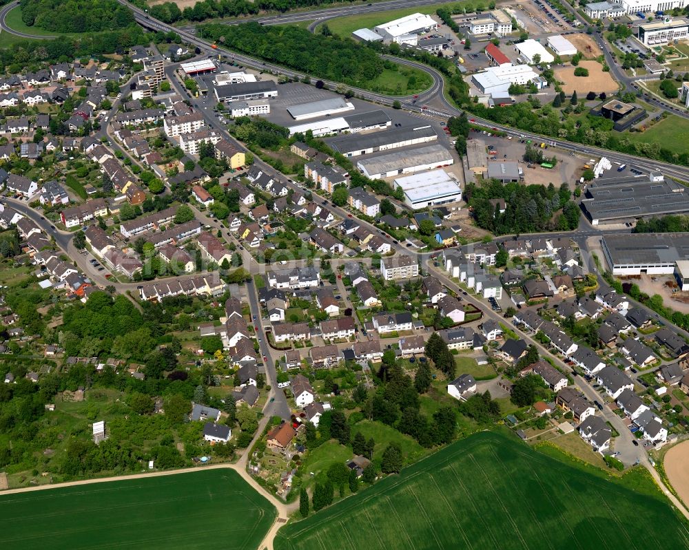 Andernach from above - Industrial and residential area in the South of Andernach in the state of Rhineland-Palatinate. The town is located in the county district of Mayen-Koblenz on the left riverbank of the river Rhine. The town is characterised by industry, consists of five boroughs and districts and belongs to the oldest towns in Germany. The industrial area is located on the federal highway B9 and includes several production halls and industrial facilities. A residential area with single family houses and gardens is located adjacent to it