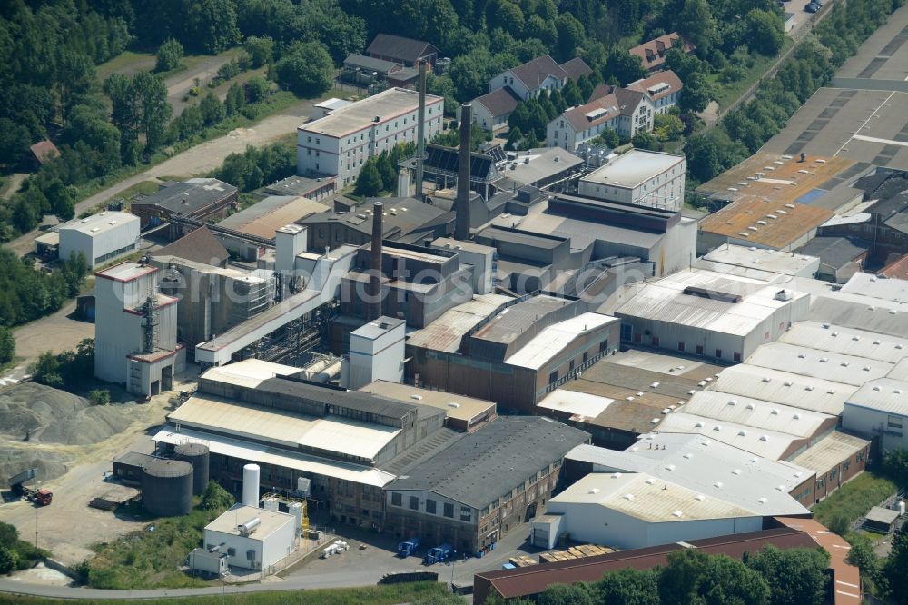 Obernkirchen from above - Industrial compound and production site of Ardagh Glass in Obernkirchen in the state of Lower Saxony. The large site with different buildings, halls and the large distinct hall with red-brown roof is the site of two Ardagh Glass companies that produce for the international glass industry: Heye International and Schaumburger Formenbau GmbH