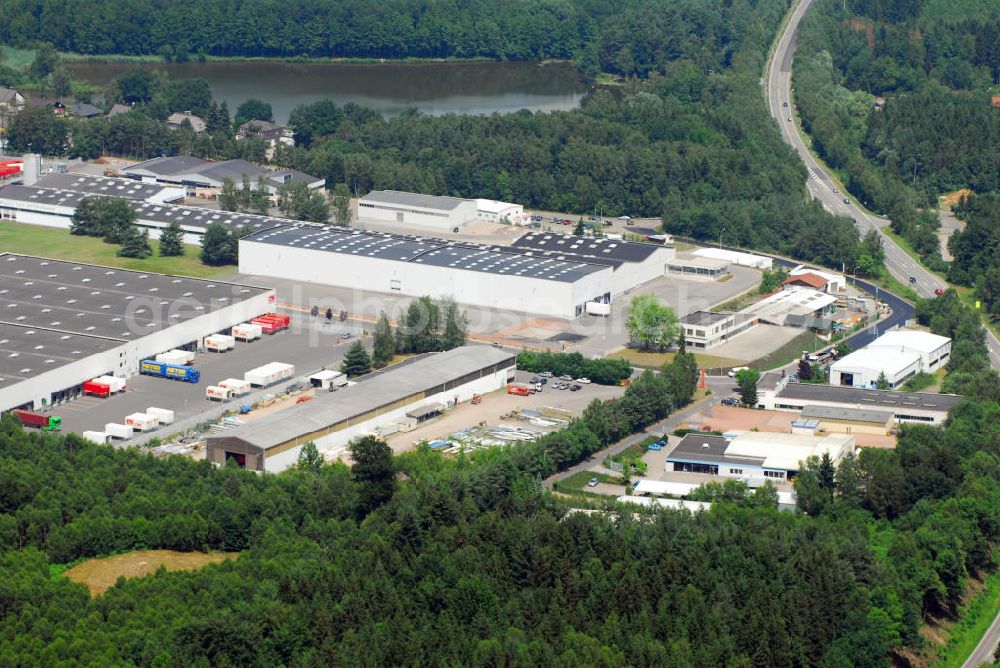 Aerial photograph Waldmohr - Blick auf das Industriegelände am Motschweiher in Waldmohr. Waldmohr lebt heute überwiegend von Industrie- und Handwerksbetrieben. Es ist der größte Industriestandort im Landkreis Kusel. Größter Arbeitgeber mit 590 Beschäftigten ist die Firma Schmal Möbel GmbH. In den letzten Jahren ist die Firma Minitec stark gewachsen, sie hat derzeit ca. 190 Mitarbeiter. Die Firma verfügt über ein Patent für Aluminiumprofile, bei denen keine Bohrungen mehr notwendig sind. Kontakt: CS Schmalmöbel GmbH & Co. KG, Industriestr. 27, 66914 Waldmohr, Tel.: 06373-821-0,