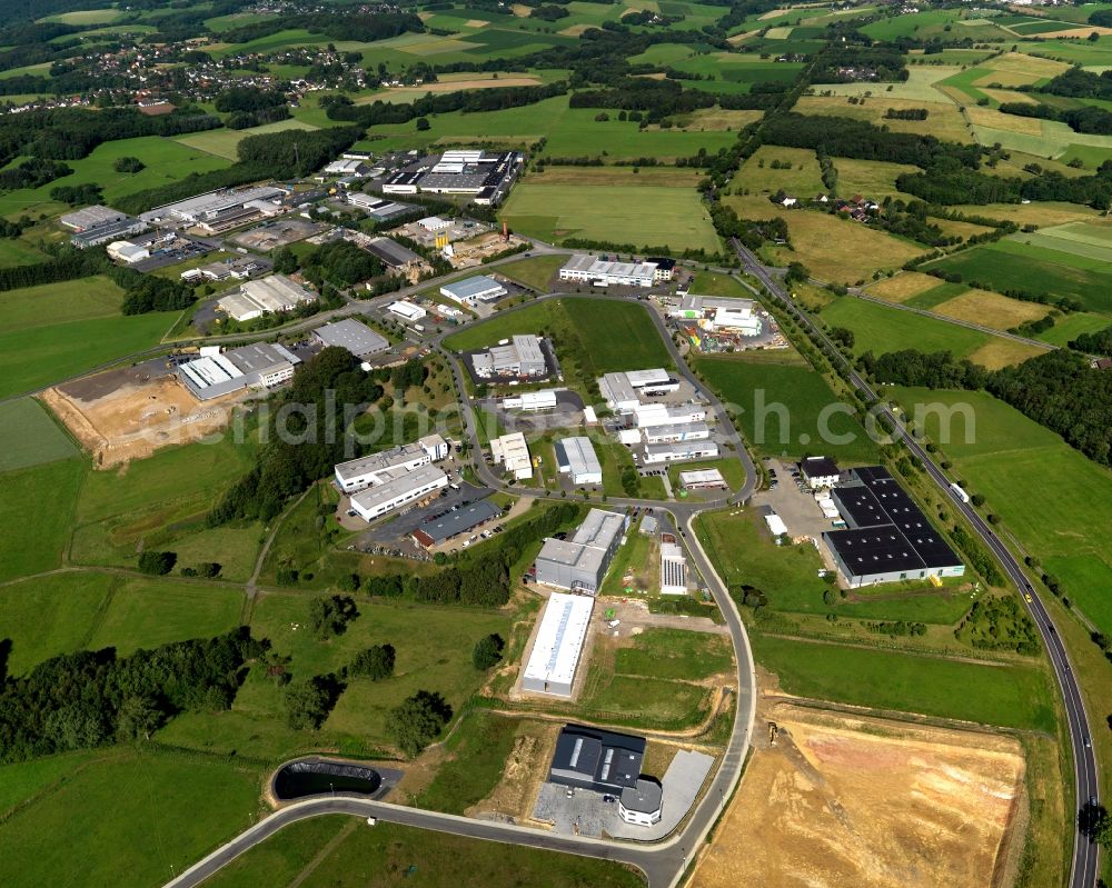 Aerial photograph Buchholz - Industrial area Industriepark Nord of Buchholz in the state of Rhineland-Palatinate. The borough and municipiality Buchholz is located in the county district of Neuwied on the edge of the Westerwald forest region and surrounded by fields, meadows and hills. The industrial area is located in the North of Buchholz and is the site of stores and companies of the car and motorbike industry