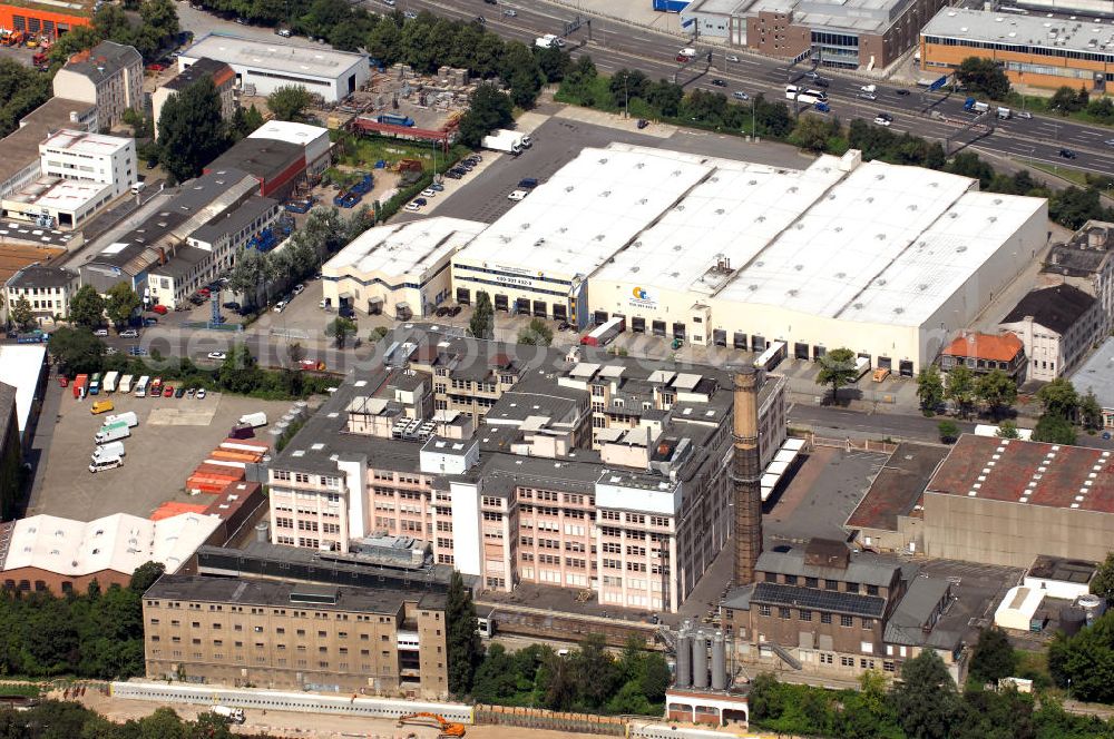 Aerial photograph Berlin - Blick auf einen Teilausschnitt der Teilestraße, eine Industriestraße im Industrie-Gebiet Tempelhof-Ost, die am Teltowkanal liegt. Im Vordergrund befindet sich die Fabrik der Ikad Europe GmbH, die auch als ehemaliges Sarotti-Werk bekannt ist. Im Hintergrund ist das Logistikzentrum des Cash Carry Lebensmittel- und Getränke- Großhandelskontor ansässig. Kontakt: