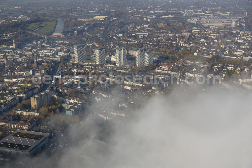 Mülheim an der Ruhr from above - Inner city with the four residential towers behind deep autumnal clouds at Muelheim an der Ruhr in the Ruhr area in North Rhine-Westphalia