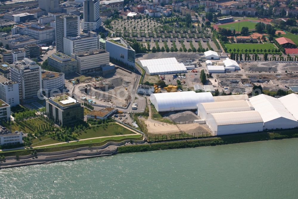 Basel from above - City area on the banks of river Rhine at Novartis Campus in Basel, Switzerland, and just over the border the tends of the remediation area ARA Steih in Huningue, France