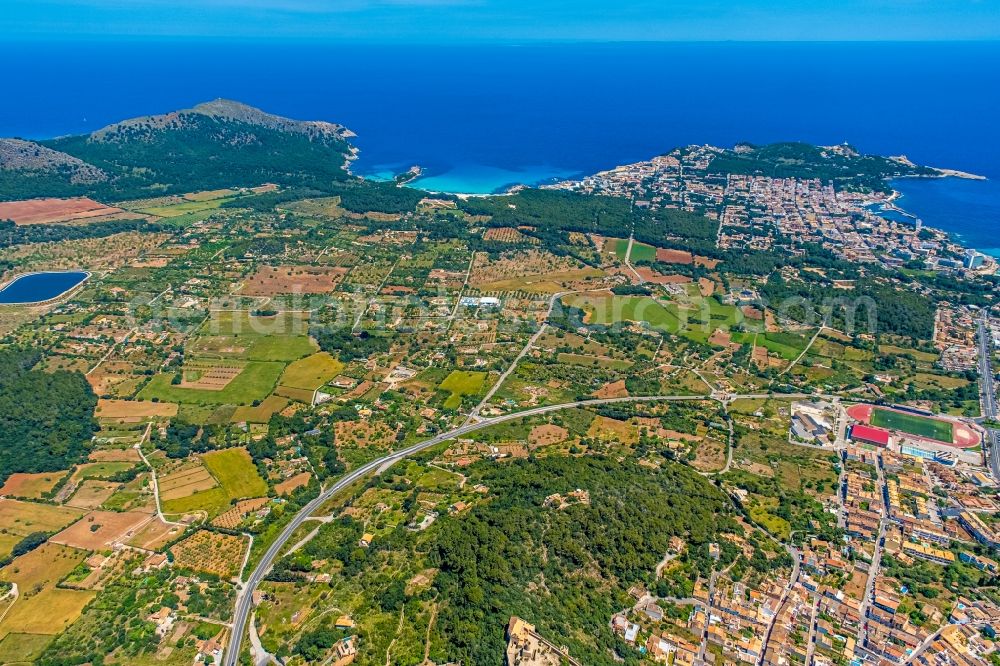 Aerial photograph Capdepera - City view from the downtown area with the outskirts with adjacent agricultural fields along the course of the Ma-15 in Capdepera in Balearic island of Mallorca, Spain