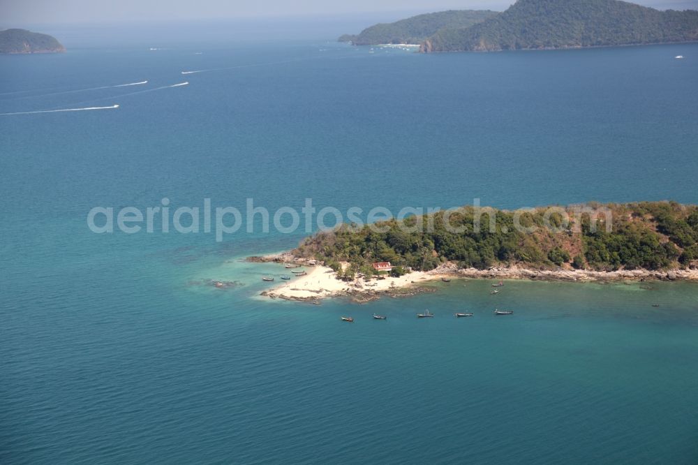 Aerial image Rawai - The island of Ko bon with palm trees, sandy beach and fishing boats is in the bay in front of the city Rawai on the island of Phuket in Thailand