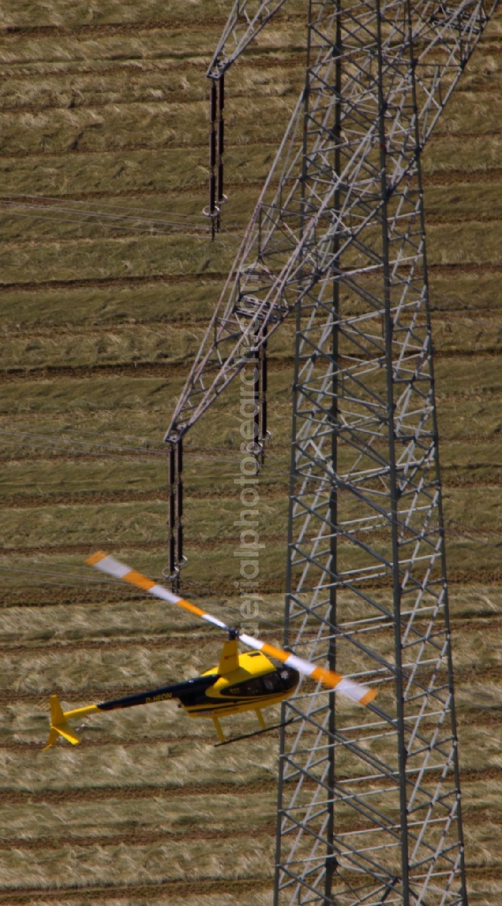 Aerial image Drensteinfurt - Inspection of poles and power lines of a utility by a helicopter flying low at Drensteinfurt in North Rhine-Westphalia