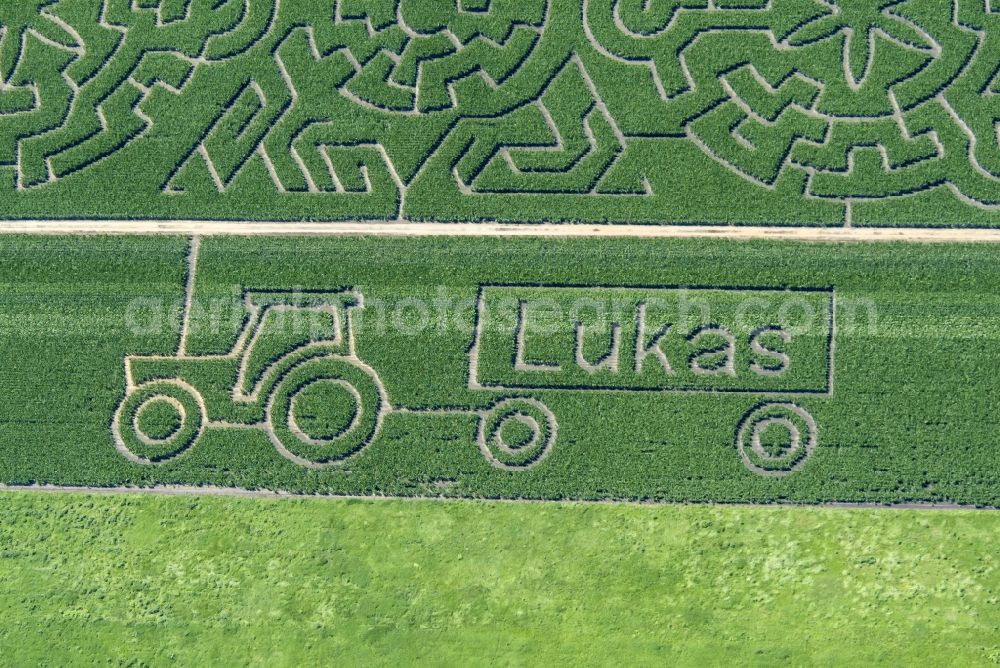 Atting from the bird's eye view: Maze - Labyrinth with the outline of a tractor with LUKAS - Trailer in a field in Atting in the state Bavaria