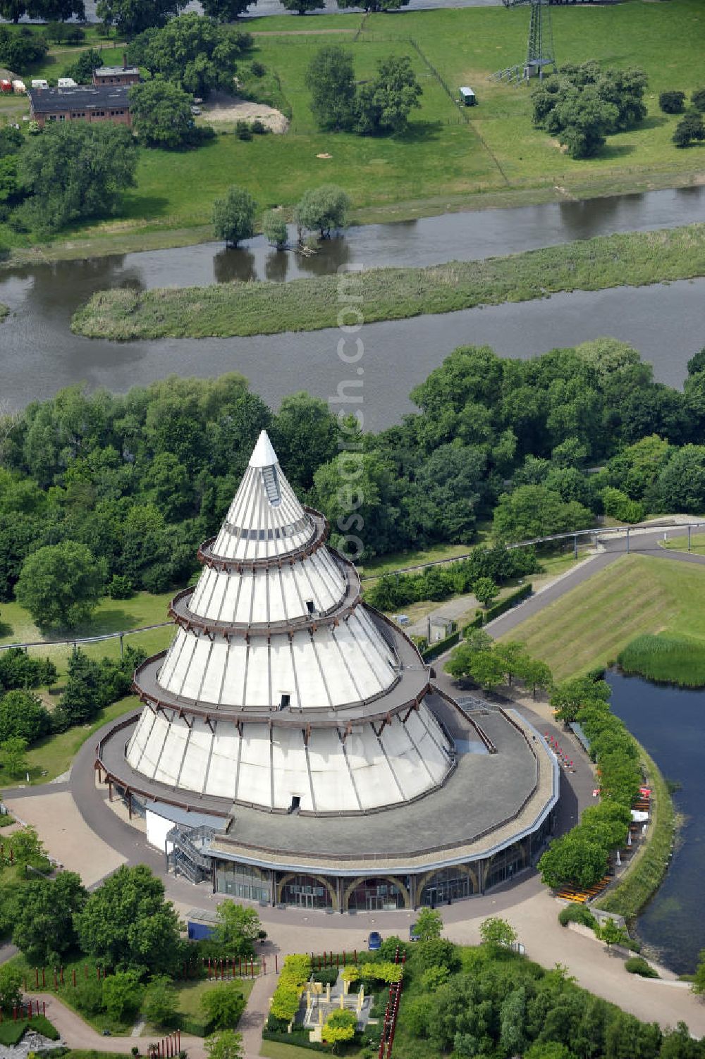 Aerial image Magdeburg - Blick auf den Jahrtausendturm im Elbauenpark, auch als die BUGA - Pyramide bekannt. Der Jahrtausendturm in Magdeburg ist mit 60 Metern Höhe das höchste Holzgebäude Deutschlands und wurde anlässlich der Bundesgartenschau 1999 errichtet. Betreiber ist die Messe- und Veranstaltungsgesellschaft Magdeburg GmbH. View of the Millennium Tower in Elbauenpark. The Millennium Tower in Magdeburg is 60 meters is the tallest wooden building in Germany and was built at the Federal Garden Show 1999th