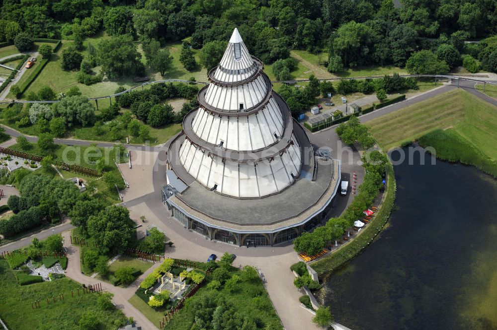 Aerial photograph Magdeburg - Blick auf den Jahrtausendturm im Elbauenpark, auch als die BUGA - Pyramide bekannt. Der Jahrtausendturm in Magdeburg ist mit 60 Metern Höhe das höchste Holzgebäude Deutschlands und wurde anlässlich der Bundesgartenschau 1999 errichtet. Betreiber ist die Messe- und Veranstaltungsgesellschaft Magdeburg GmbH. View of the Millennium Tower in Elbauenpark. The Millennium Tower in Magdeburg is 60 meters is the tallest wooden building in Germany and was built at the Federal Garden Show 1999th