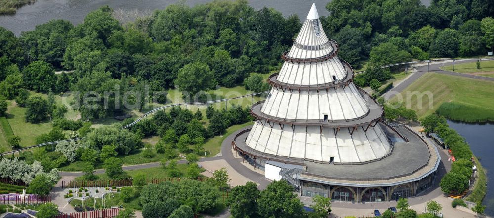 Magdeburg from the bird's eye view: Blick auf den Jahrtausendturm im Elbauenpark, auch als die BUGA - Pyramide bekannt. Der Jahrtausendturm in Magdeburg ist mit 60 Metern Höhe das höchste Holzgebäude Deutschlands und wurde anlässlich der Bundesgartenschau 1999 errichtet. Betreiber ist die Messe- und Veranstaltungsgesellschaft Magdeburg GmbH. View of the Millennium Tower in Elbauenpark. The Millennium Tower in Magdeburg is 60 meters is the tallest wooden building in Germany and was built at the Federal Garden Show 1999th