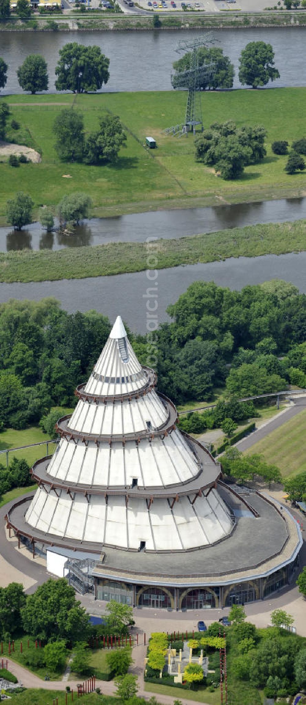 Aerial image Magdeburg - Blick auf den Jahrtausendturm im Elbauenpark, auch als die BUGA - Pyramide bekannt. Der Jahrtausendturm in Magdeburg ist mit 60 Metern Höhe das höchste Holzgebäude Deutschlands und wurde anlässlich der Bundesgartenschau 1999 errichtet. Betreiber ist die Messe- und Veranstaltungsgesellschaft Magdeburg GmbH. View of the Millennium Tower in Elbauenpark. The Millennium Tower in Magdeburg is 60 meters is the tallest wooden building in Germany and was built at the Federal Garden Show 1999th