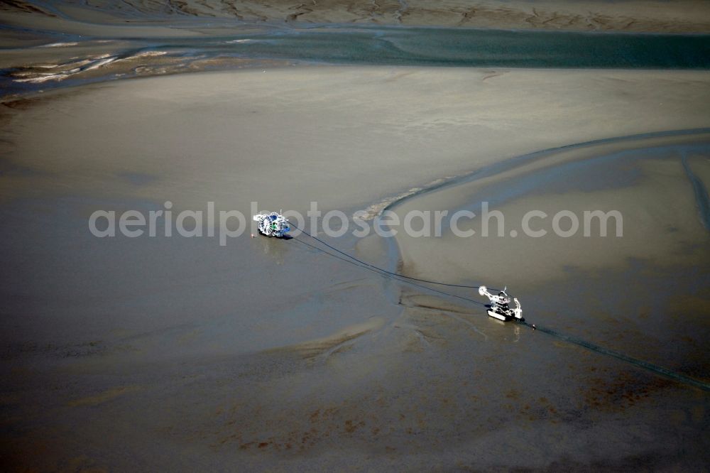 Cuxhaven from above - Cablecaster and cable installation machine in the Wadden Sea between the island of Neuwerk and Cuxhaven in the state of Lower Saxony. The cablecaster is working in the mud of the coastal region in front of Neuwerk