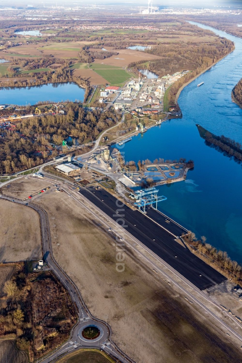 Lauterbourg from above - Wharves and piers with ship loading terminals in the new inner harbor at the Rhine river in Lauterbourg in Grand Est, France