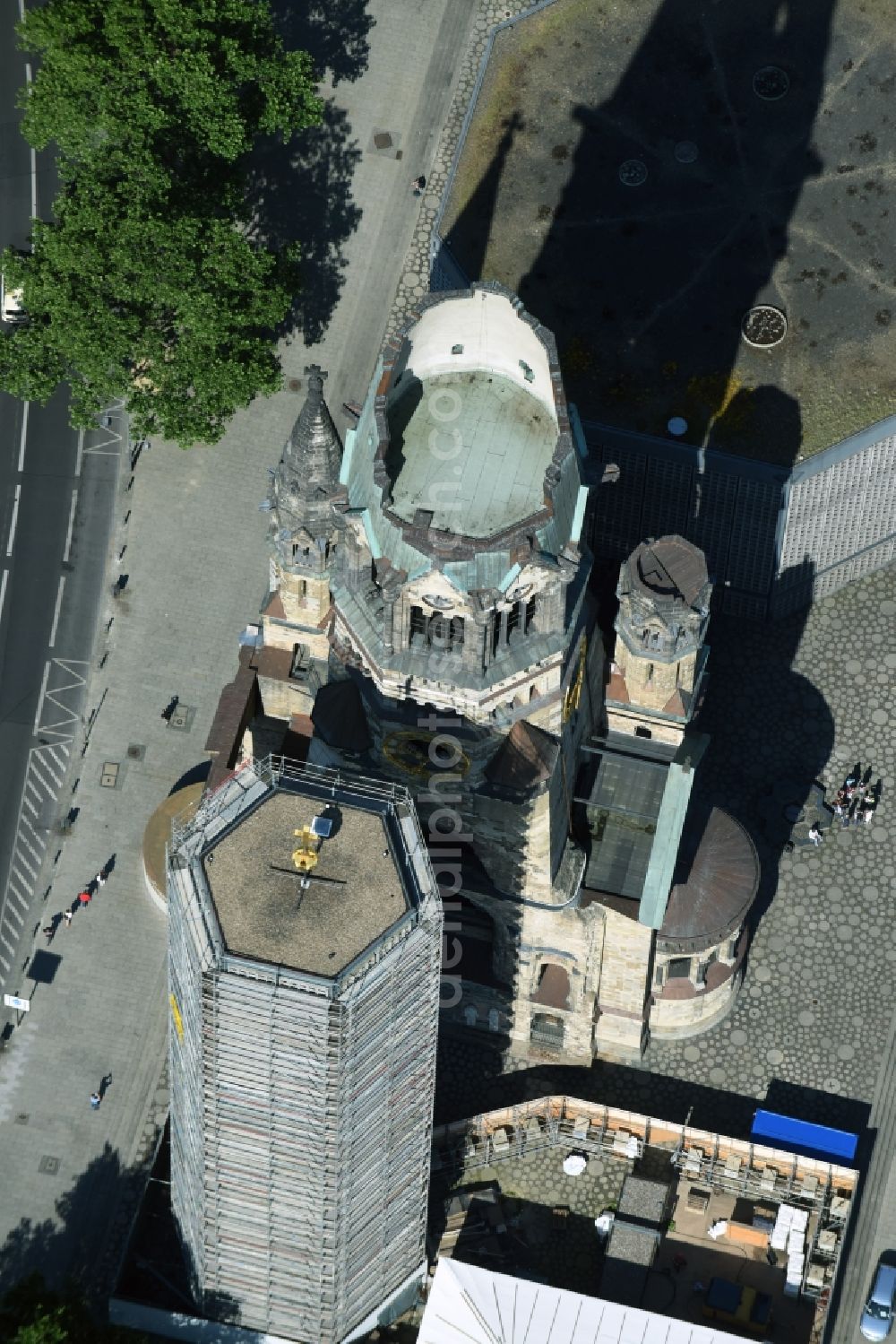 Aerial photograph Berlin - The Protestant Kaiser William Memorial Church, commonly short memorial church stands on the Breitscheidplatz between the Kurfuerstendamm, the Tauentzienstrasse and the Budapest street in Berlin's Charlottenburg district. The non-damaged part of the old church is now a museum and war memorial