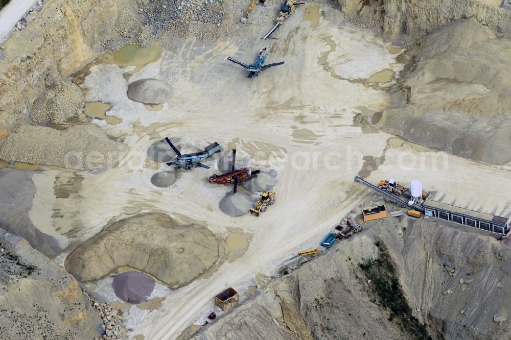Aerial photograph Gutendorf - View of the guarry of limestone in Gutendorf with two quarry machines in the state of Thuringia. The limestone quarry is operated by the MKW Mitteldeutsche Hartstein- Kies- und Mischwerke GmbH