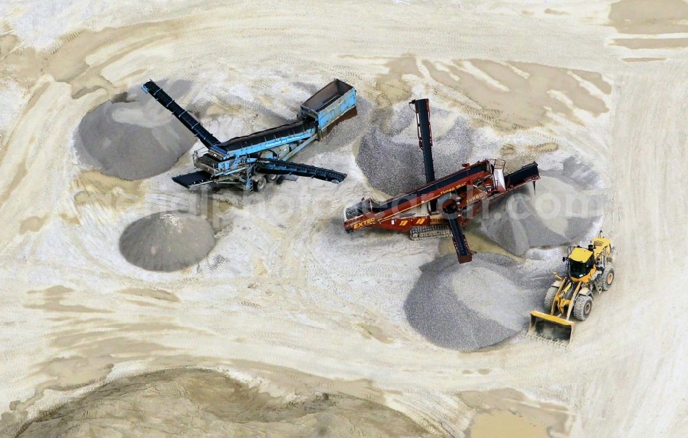 Gutendorf from above - View of the guarry of limestone in Gutendorf with two quarry machines in the state of Thuringia. The limestone quarry is operated by the MKW Mitteldeutsche Hartstein- Kies- und Mischwerke GmbH