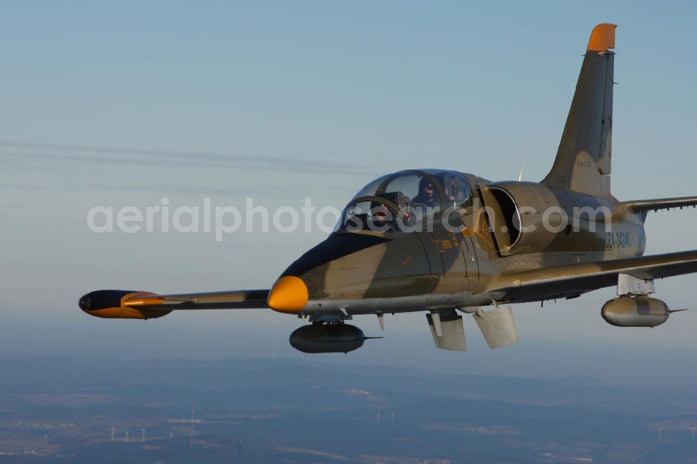 Aerial photograph Bitburg - Kampfjet Aero L-39 Albatros auf dem Flugplatz Bitburg EDRB / Rheinland-Pfalz. Die L-39 war ursprünglich als einstrahliges Schulflugzeug der tschechischen Luftstreitkräfte entwickelt worden. Jet fighter Aero L-39 Albatros at the airfield Bitburg / Rhineland-Palatinate.