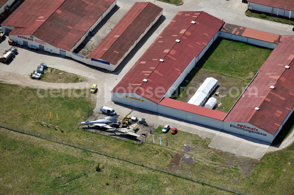 10.05.2011 from above - Kampfjet vom Typ Su-7 und MiG 23 auf dem Gelände des Gewerbezentrum Beelitz-Süd in Brandenburg. Die Su-7 stammt aus Großenhain und die MiG23 aus Jüterburg, welche gerade zu Restaurierungsarbeiten demontiert wird. A Su-7 and a MiG23 jet fighter at the Beelitz-South commercial area.