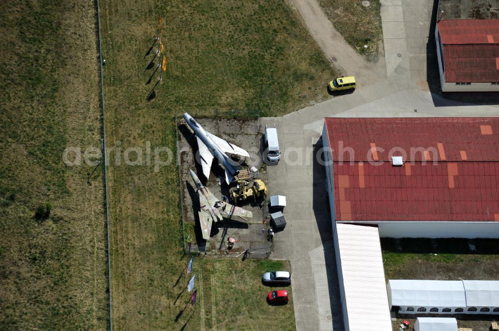 Aerial image 10.05.2011 - Kampfjet vom Typ Su-7 und MiG 23 auf dem Gelände des Gewerbezentrum Beelitz-Süd in Brandenburg. Die Su-7 stammt aus Großenhain und die MiG23 aus Jüterburg, welche gerade zu Restaurierungsarbeiten demontiert wird. A Su-7 and a MiG23 jet fighter at the Beelitz-South commercial area.