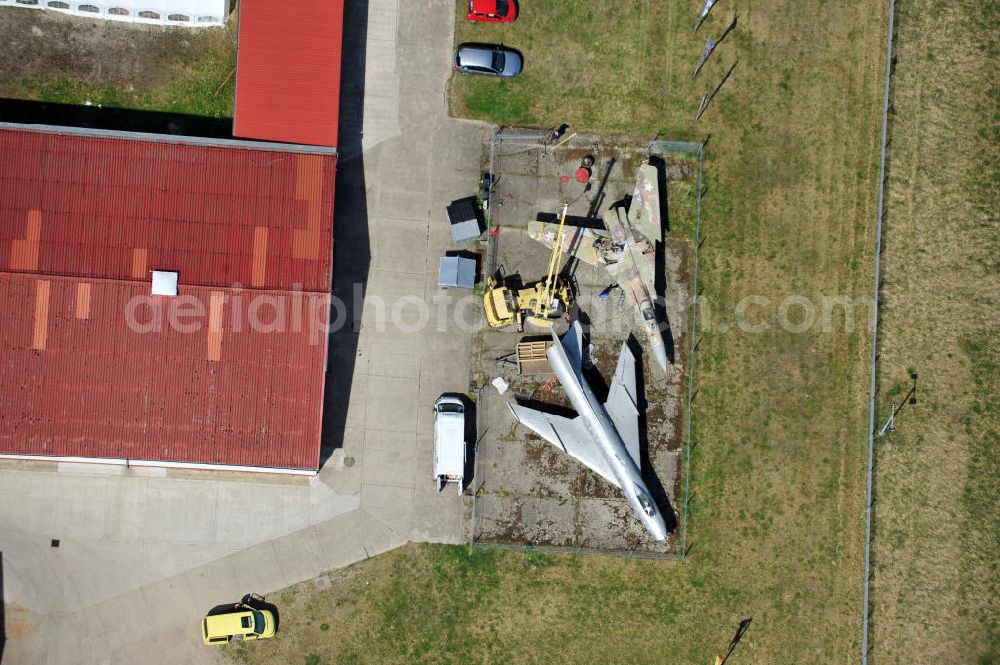 Aerial image 10.05.2011 - Kampfjet vom Typ Su-7 und MiG 23 auf dem Gelände des Gewerbezentrum Beelitz-Süd in Brandenburg. Die Su-7 stammt aus Großenhain und die MiG23 aus Jüterburg, welche gerade zu Restaurierungsarbeiten demontiert wird. A Su-7 and a MiG23 jet fighter at the Beelitz-South commercial area.