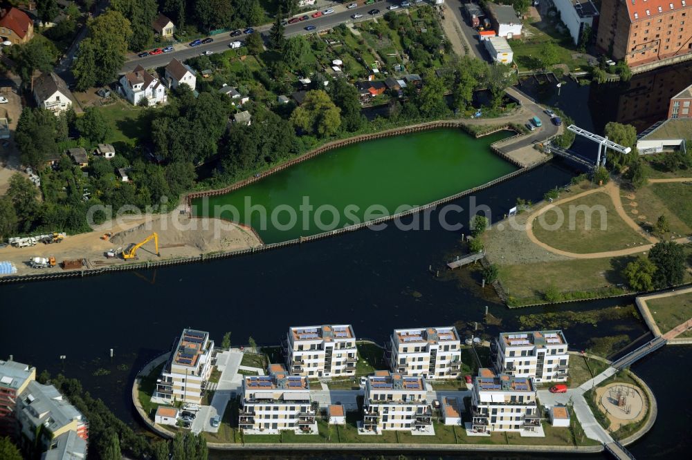 Aerial image Berlin - History channel and riparian areas with housing areas of the Tegeler Fliess at the Tegeler See in Reinickendorf in Berlin in Germany. Also shown the Tegeler Insel and the construction area at the Humboldtinsel