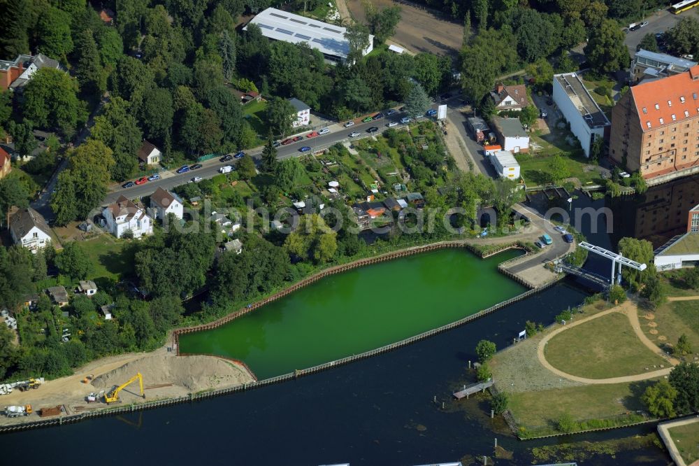 Berlin from above - History channel and riparian areas with housing areas of the Tegeler Fliess at the Tegeler See in Reinickendorf in Berlin in Germany. Also shown the Tegeler Insel and the construction area at the Humboldtinsel