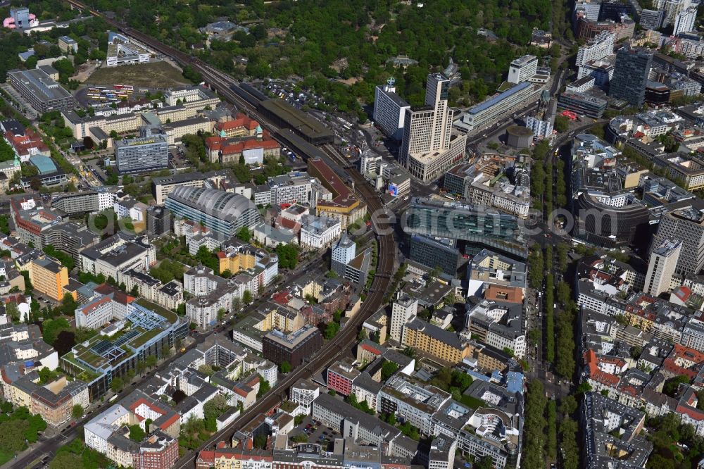 Berlin from above - With the Kantstrasse and the Kurfuerstendamm crossing two major shopping streets the Charlottenburg district of Berlin and meet at Breitscheidplatz on the City West. Here are a confined space numerous attractions and shopping centers, which makes this area attractive places for tourists. Here we find with the Kaiser Wilhelm Memorial Church is an important landmark of the city. Right next to the Zoological Garden is the shopping center Bikinihaus. The Europa Center, the Kuhdam??-Eck and the Neues Kranzler Eck and the style works in the street Kant are other popular shopping and service centers. Striking in the field of civil old buildings are the modern architecture of skyscraper Zoofenster with the luxury Waldorf Astoria Hotel and the silver barrel roof of Industry and Commerce in the pheasant road. The Zoo station is the transport links for the City West